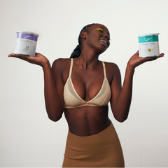 Woman holding two wax cans of a depileve wax product against a white background